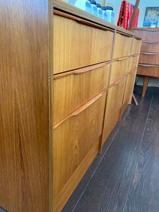 Beautiful smaller MCM teak 9 drawer credenza. Beautiful teak grain front with sculpted teak pulls-Cook Street Vintage