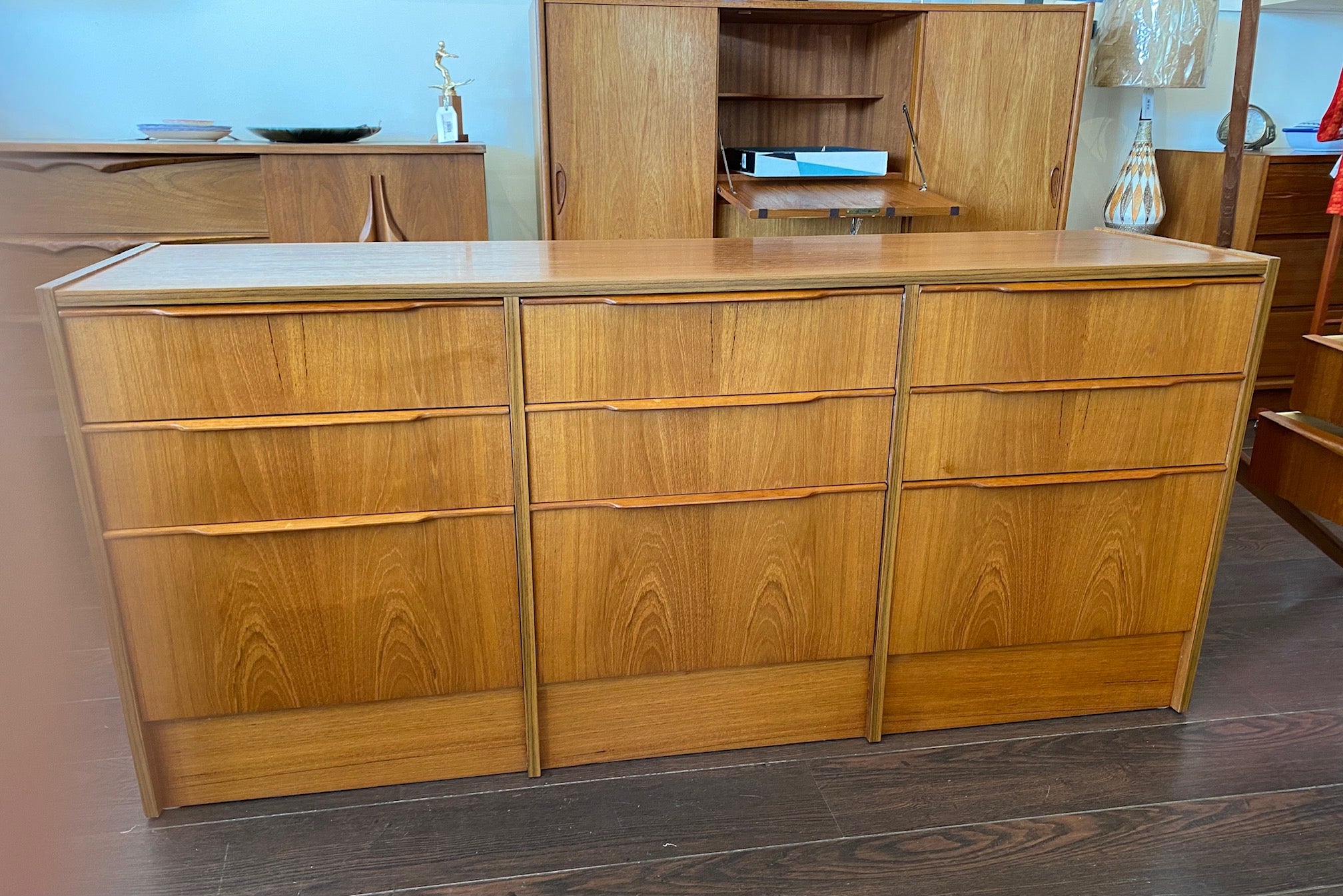 Beautiful smaller MCM teak 9 drawer credenza. Beautiful teak grain front with sculpted teak pulls-Cook Street Vintage
