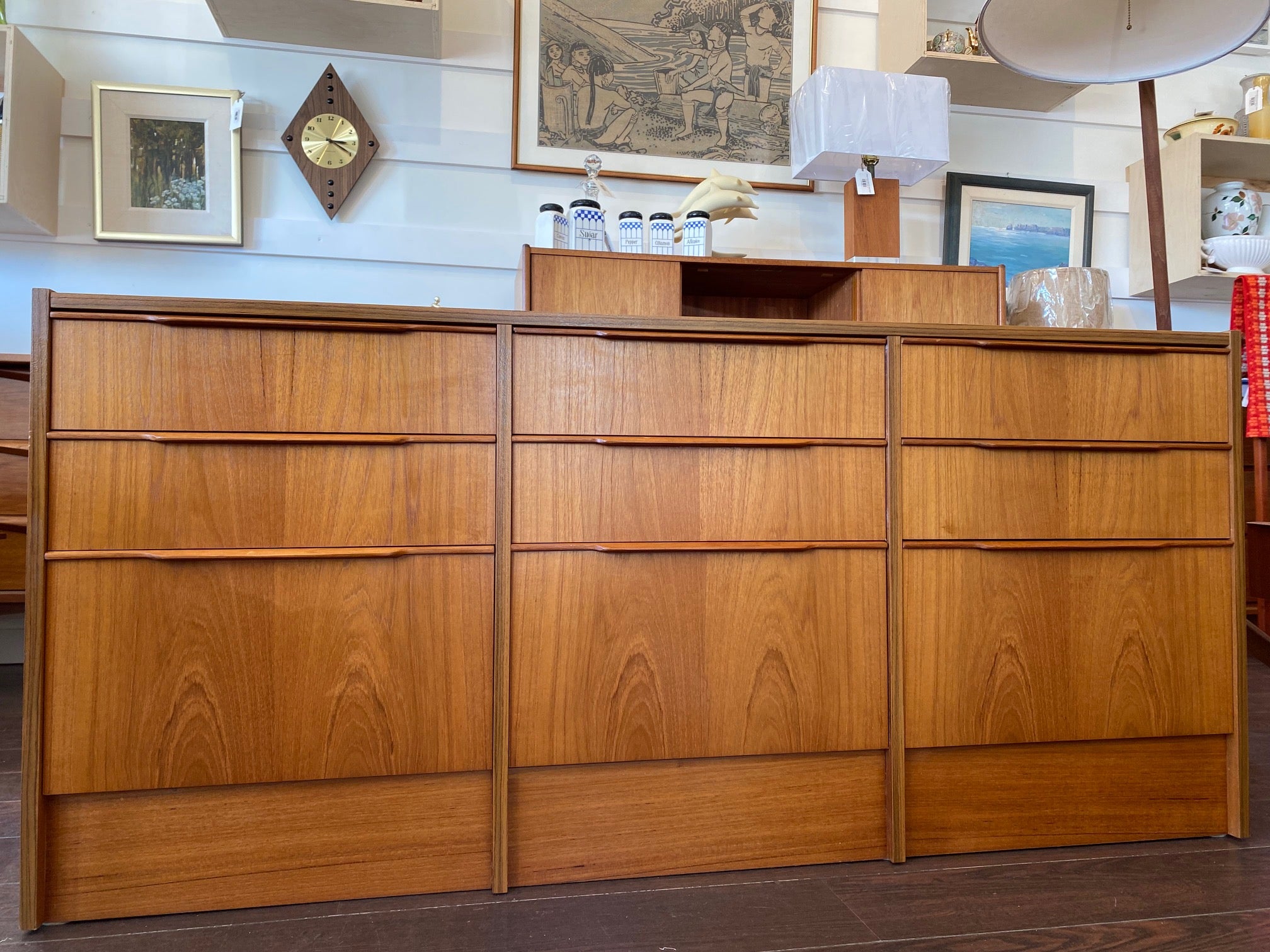 Beautiful smaller MCM teak 9 drawer credenza. Beautiful teak grain front with sculpted teak pulls-Cook Street Vintage